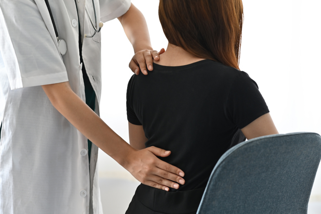 back-pain-specialist-assessing-woman-with-back-pain-due-to-muscle-strain-or-postural-imbalance